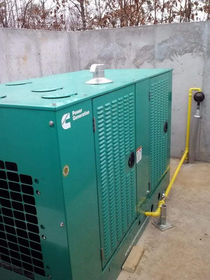 Cummins standby generator installed on a pad with a gas line connection