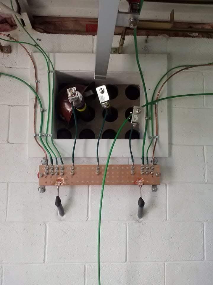Copper ground bar with bonded conductors at a communications entrance